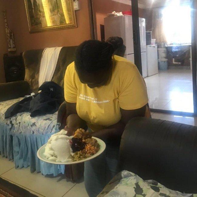 woman kneeling to serve husband food