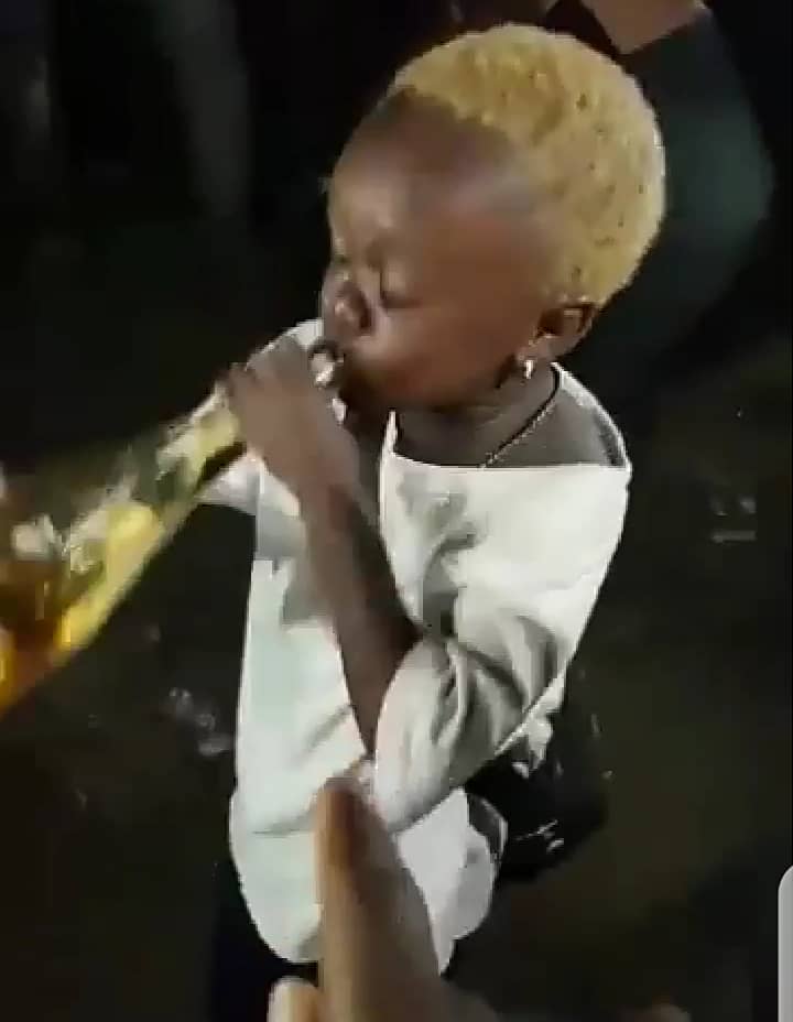 "Allow me to enjoy myself" - Little boy screams while consuming bottle of alcoholic drink amid cheers (Video)