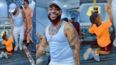 Little boy leaves crowd in awe as he goes on both knees to greet Davido