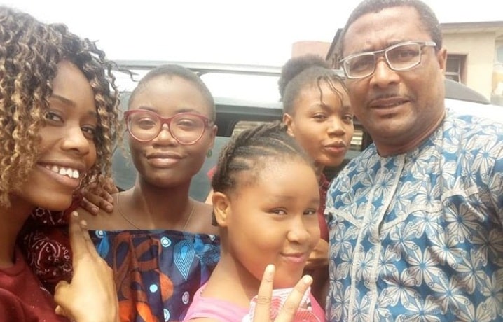 Tony Umez poses with his four daughters