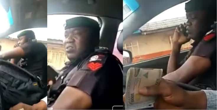 Policeman seen extorting money from a motorist (video)