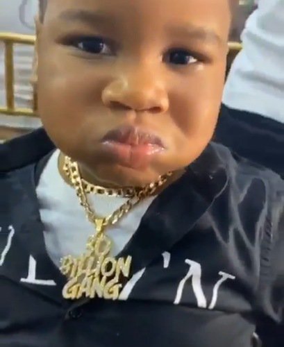 Boy consumes beer at a party