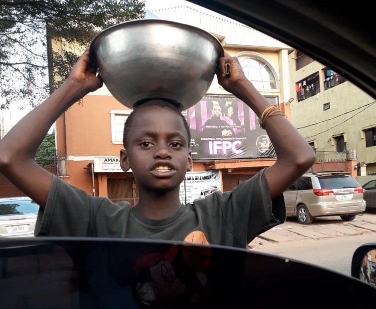 Young boy hawking sachet water gets scholarship, house, business for mom after stranger shared a video of him online