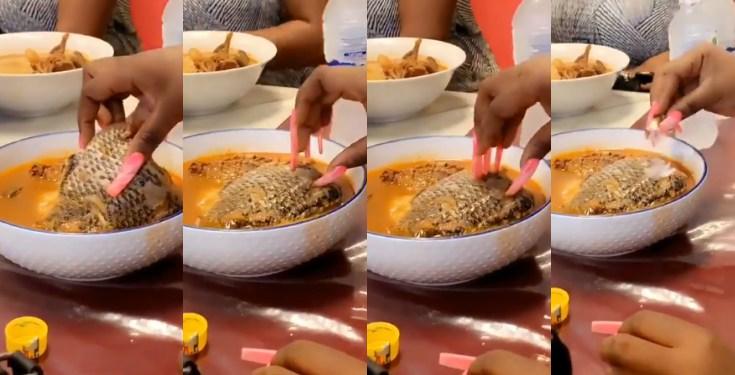 Moment lady struggles to eat fish with long attached nails (Video)