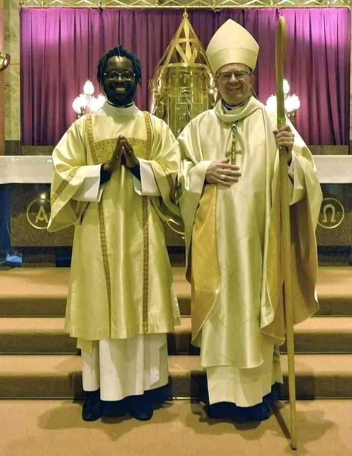 Man with dreadlocks as Catholic Priest