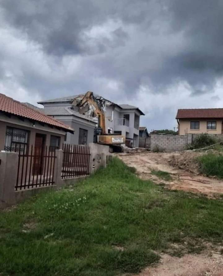 Lady poses on demolished house