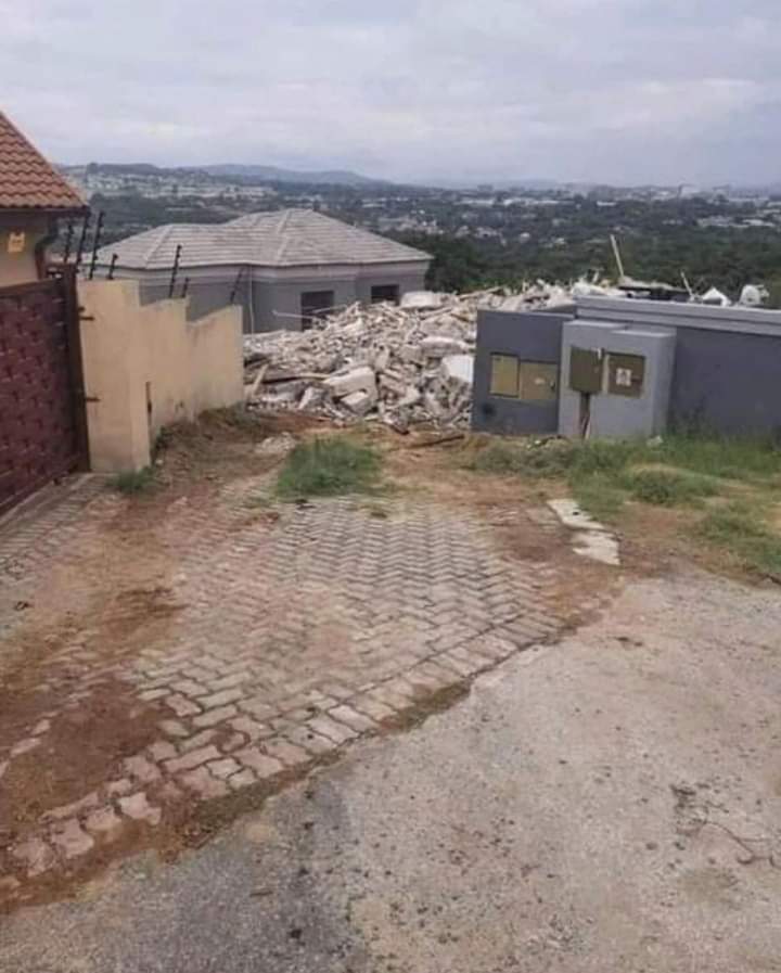 Lady poses on demolished house