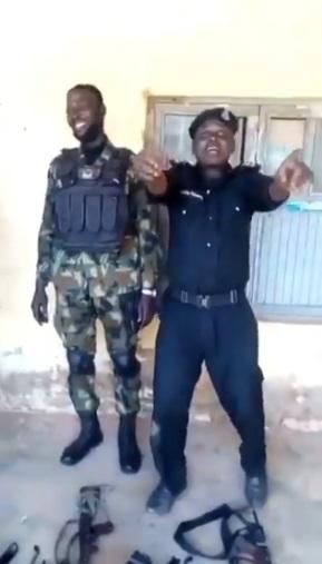 Police Officer becomes laughing stock after struggling to assemble gun while competing with Soldier (Video)