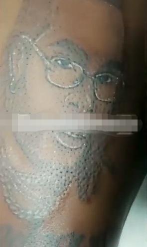 Lady tattoos Burna Boy's face and name of her lap and chest (Video)
