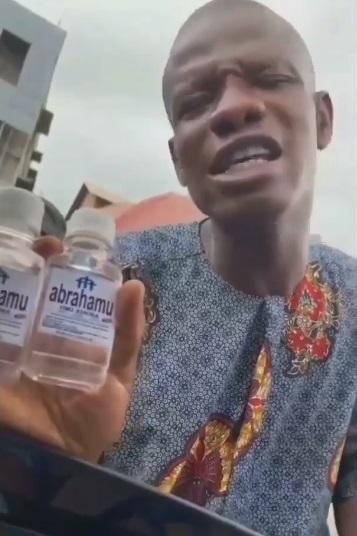 Pastor spotted selling N200 'get rich' holy water in Lagos traffic (Video)