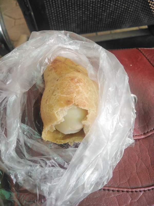 Lady in shock after finding whole boiled egg inside meat pie