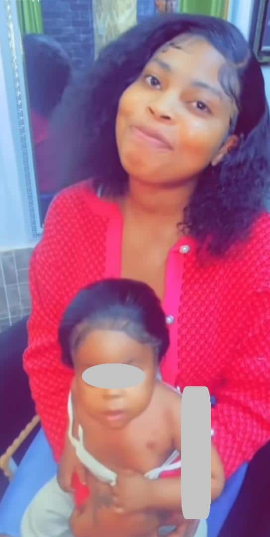 "When a child gives birth to a child" - Lady bashed for fixing wig on a year old child (Video)