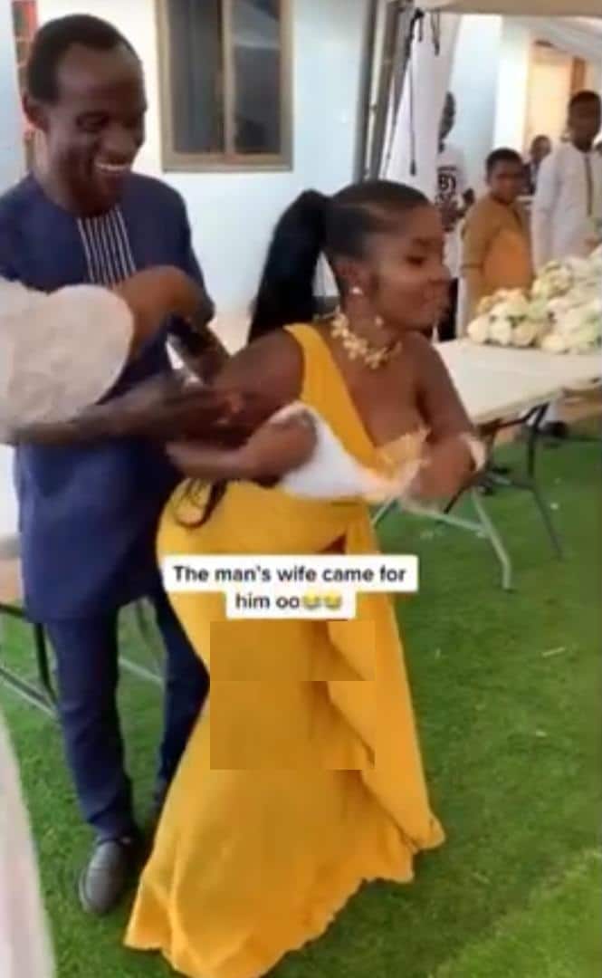 Moment wife rushes in to rescue husband from overzealous wedding guest (Video)