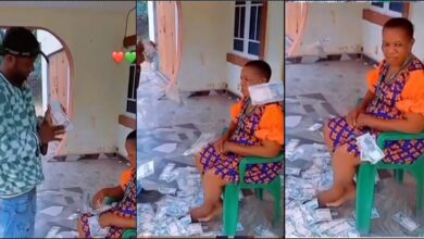 Mother acts unbothered as son sprays her loads of cash (Video)