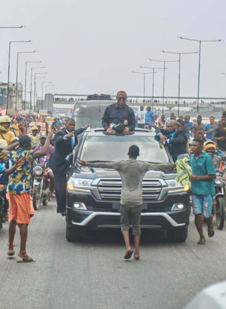 yusuf alami boy standing in front of peter obi's convoy