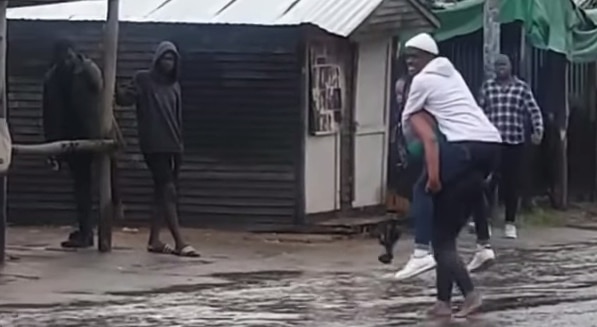 Man lady crossing flood