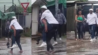 Man girlfriend back cross flooded road