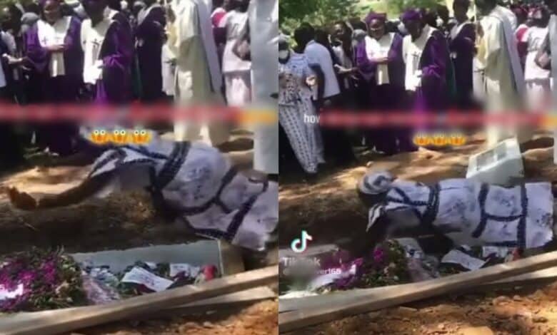 Lady jumps on coffin during burial