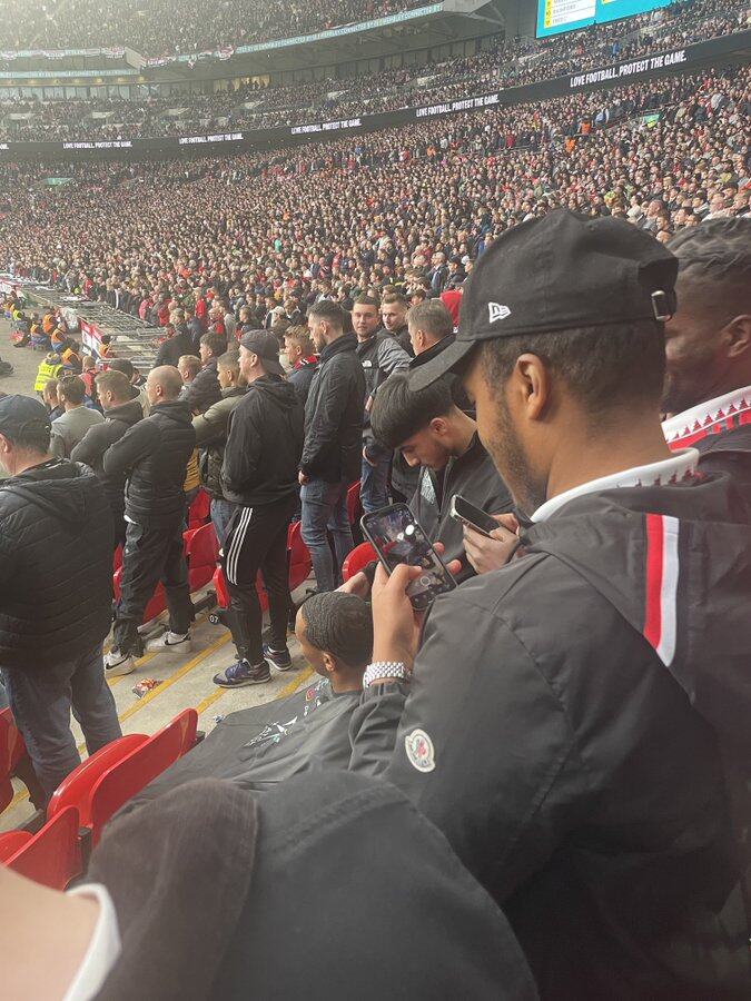 Fan spotted getting haircut inside Wembley during Manchester United vs. Brighton match