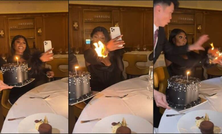 Moment lady's outfit catches fire while making video of birthday cake