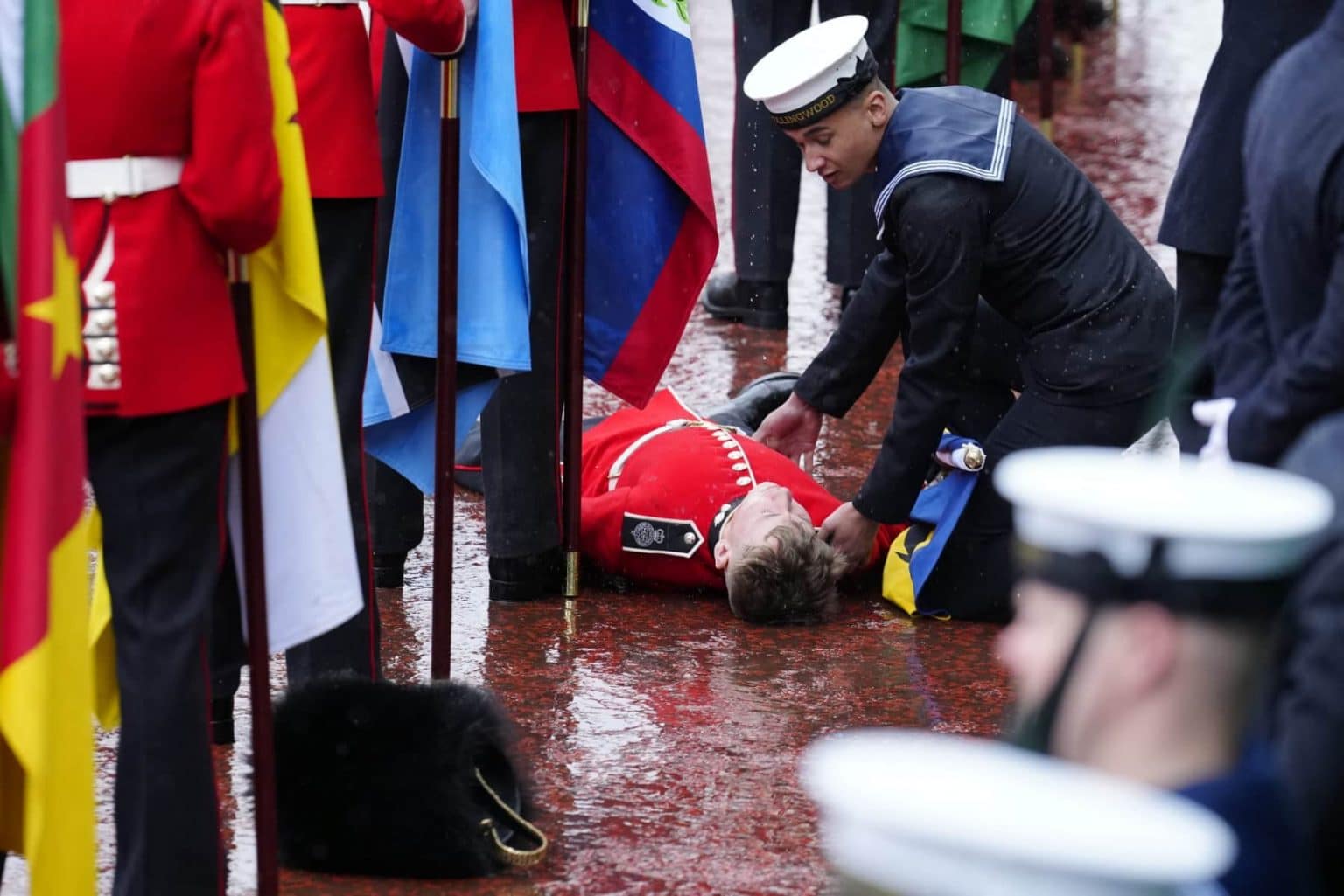 Flagbearer slumps during coronation of King Charles