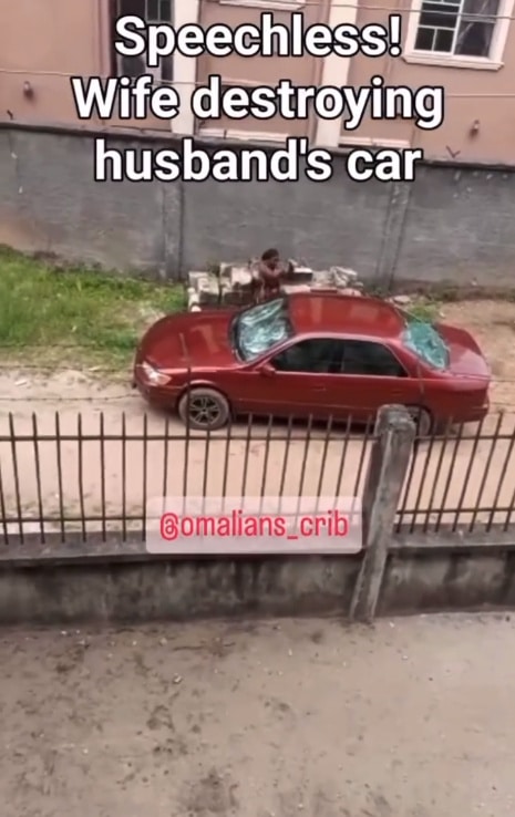 Nigerian lady destroys husband's car with a stone 