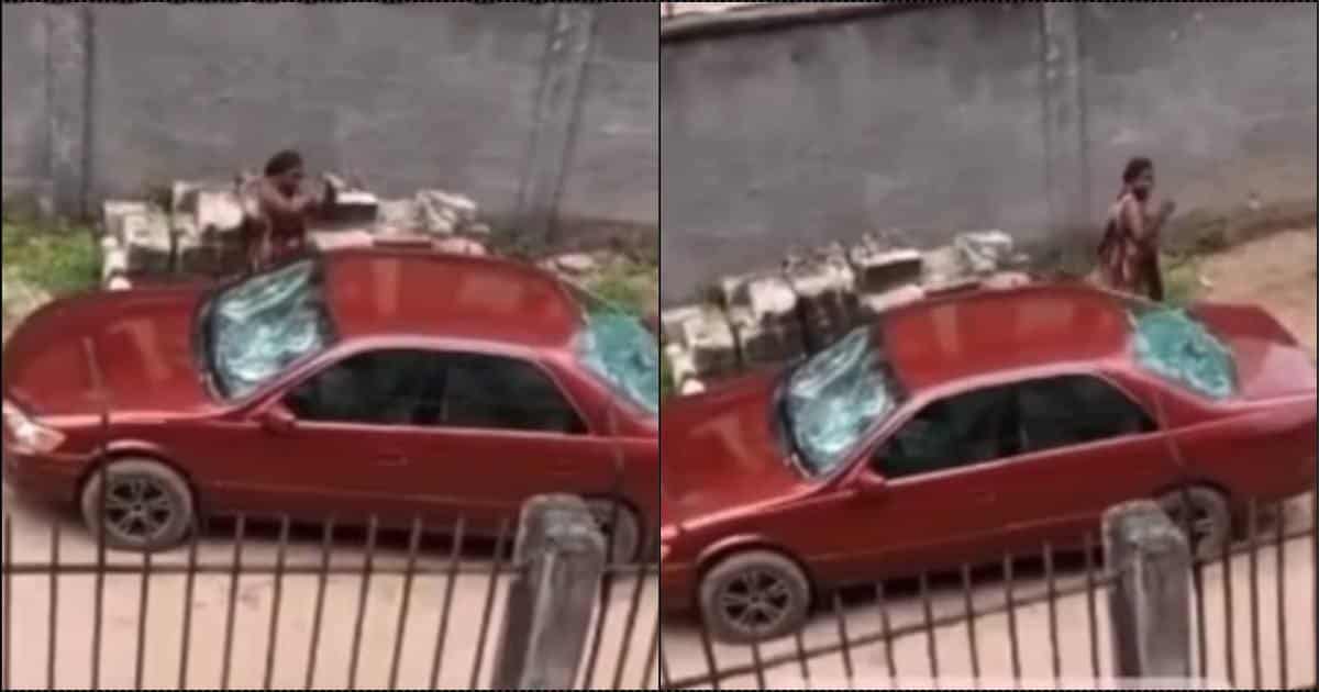 Moment Nigerian lady destroys husband's car with stone (Video)