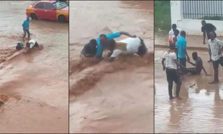 Moment onlookers rescue man trapped in flood (Video)