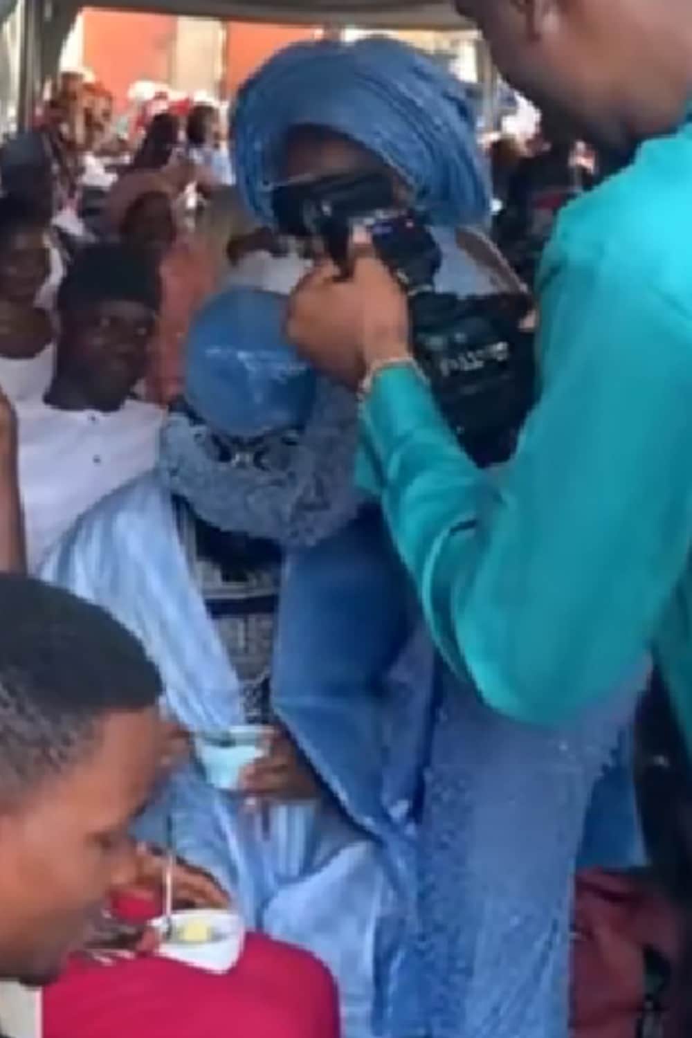 "Hilarious moment"- Nigerian bride takes away food from foodie groom eating at his own wedding (video)