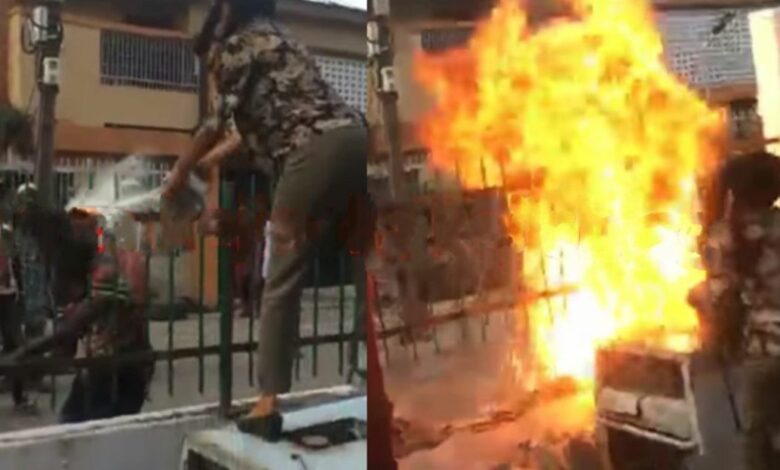 woman sets fire on fence to repel landgrabbers attempting to take over family house in Lagos.