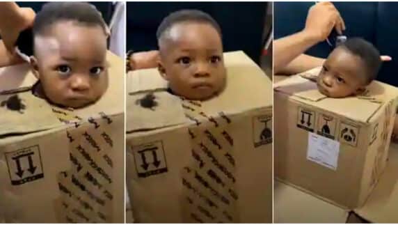"This pikin no get joy" - Father puts troublesome son inside box to barb his hair