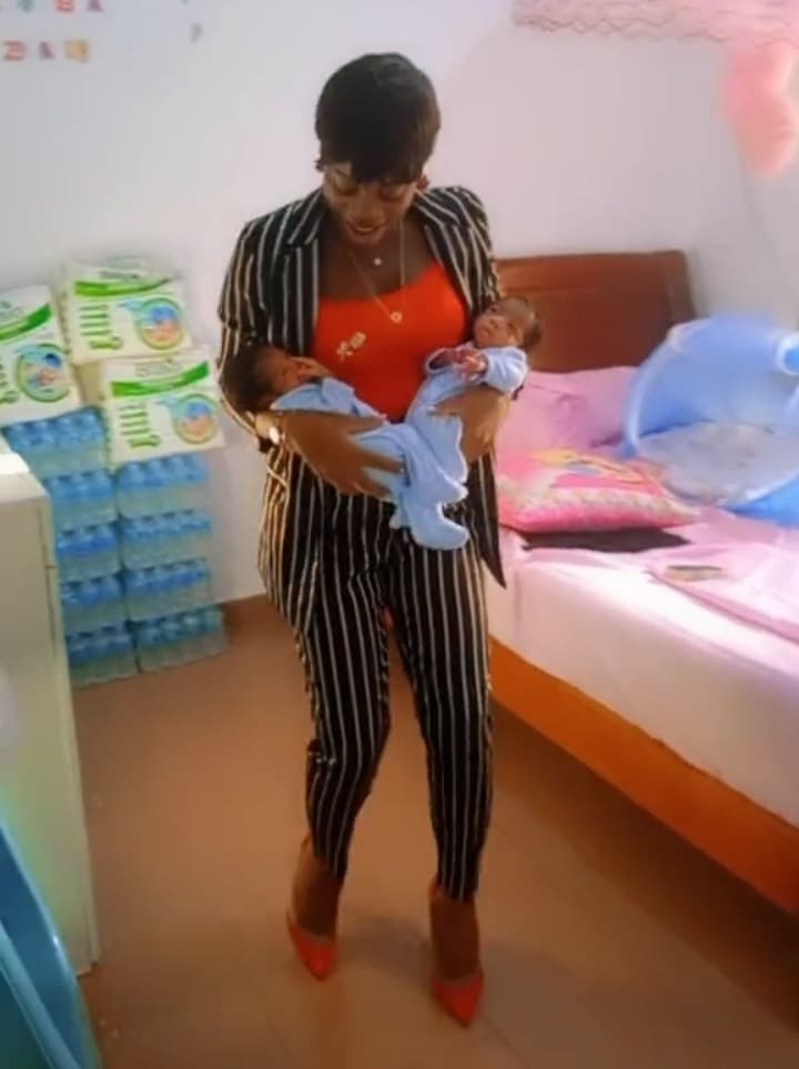 Excited mother dances with her twin babies