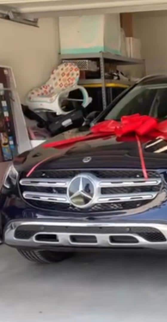 Overjoyed Simi goes down on her knees as Adekunle Gold gifts her Mercedes Benz (Video)