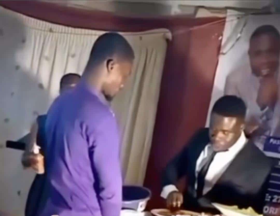 Pastor eats eba, gives members thumb to lick during communion service (Video)