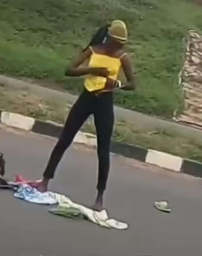 Lady runs mad after being dropped by an alleged yahoo boy in middle of a road 