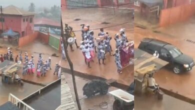 Pastor and wife chill inside car as church members walk in the rain during crusade