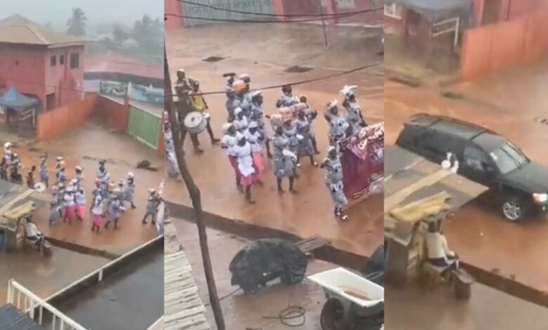 Pastor and wife chill inside car as church members walk in the rain during crusade