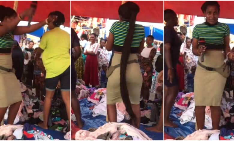 Lady selling second hand clothes in market causes buzz as she sings, shakes waist to attract customer (Video)