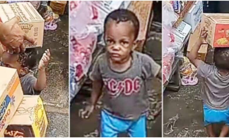 Little boy causes buzz by delivering several packs of goodies to a shop, balances them on his head