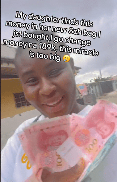 "I received almost N200k" - Woman over the moon as she finds Chinese Yuan notes inside her child’s new schoolbag (Video)