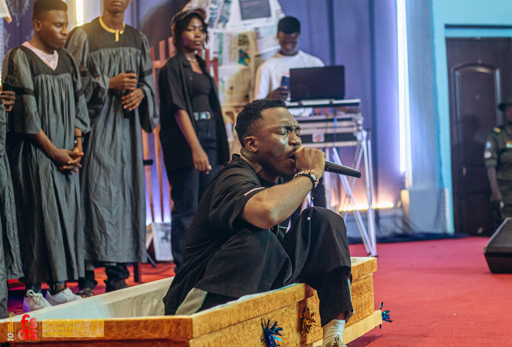 Drama as gospel singer arrives on stage in coffin to perform