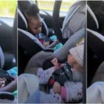 Little girl frowns face after seeing baby sister for the first time