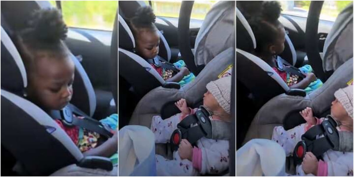 Little girl frowns face after seeing baby sister for the first time