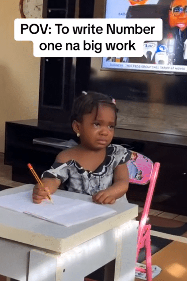"Write figure 1" - Little girl cries a river as she tries to do her maths homework, tastes her tears, mum films her drama