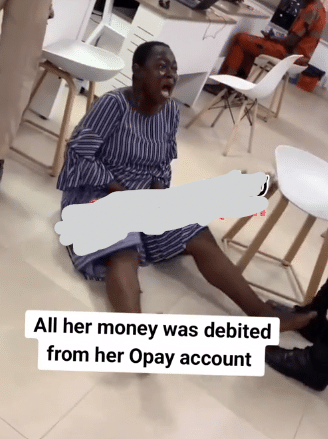 Nigerian woman throws herself on floor, weeps bitterly after all her money disappears from OPay account