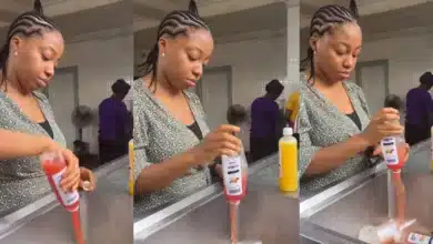 Nigerian business woman dispose several bottles of fruit juice after it got spoilt because of lack of electricity
