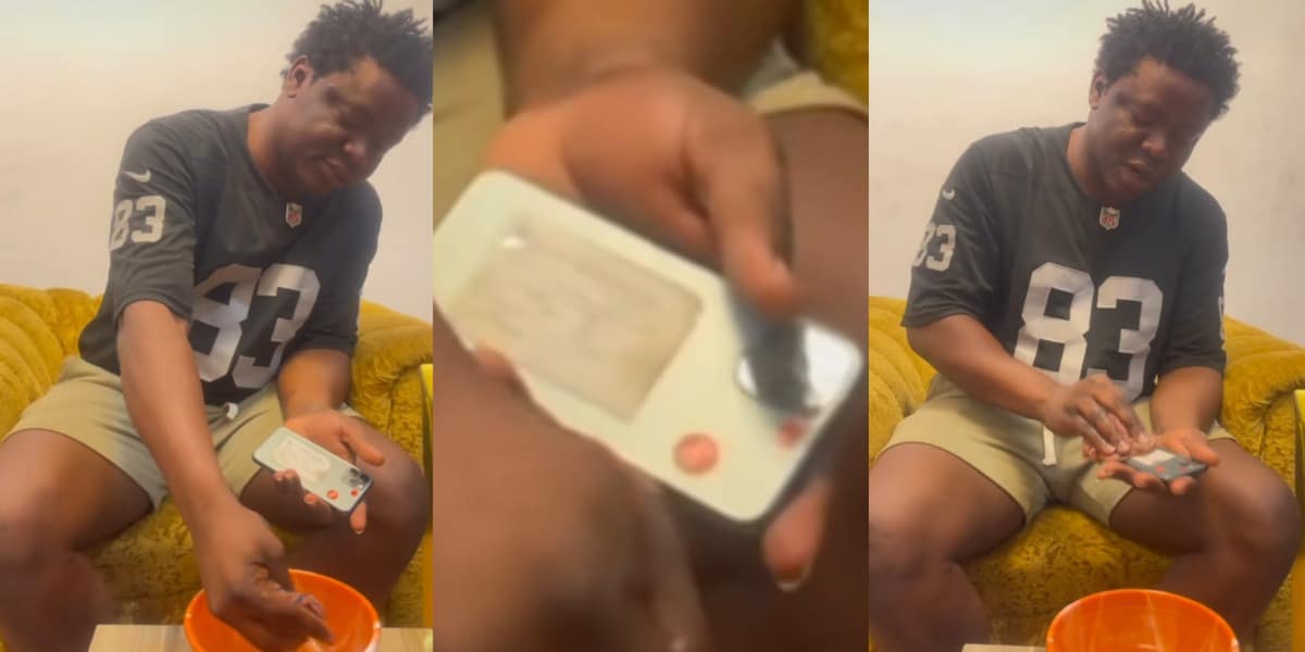 "My phone no go kill me" - Nigerian man causes stir online as he cools iPhone 12 Pro Max overheating problem with cold water