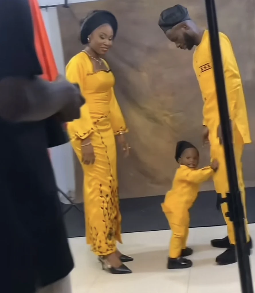 “May the best man win” — Reactions as little boy fights his father for kissing his mum during photoshoot 