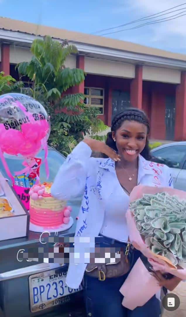 Lady blushes as boyfriend showers her with money and gifts on sign out day