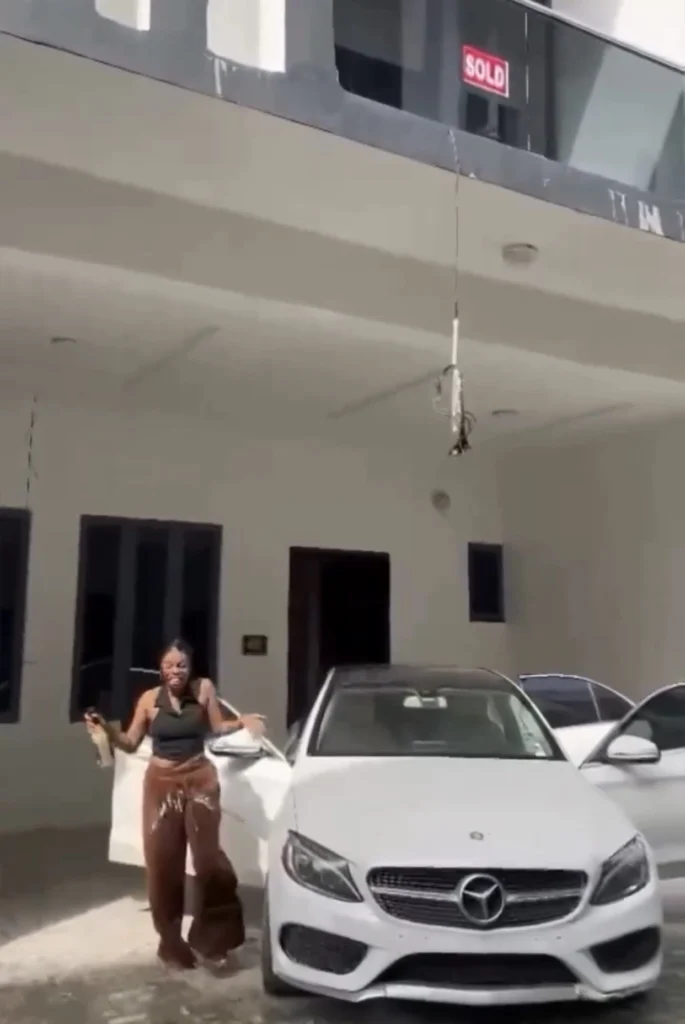 Young lady celebrates as she buys new building and Benz from her fashion design business 